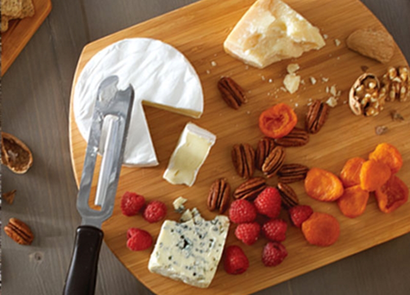 Cheese board with berries, nuts and cheese.